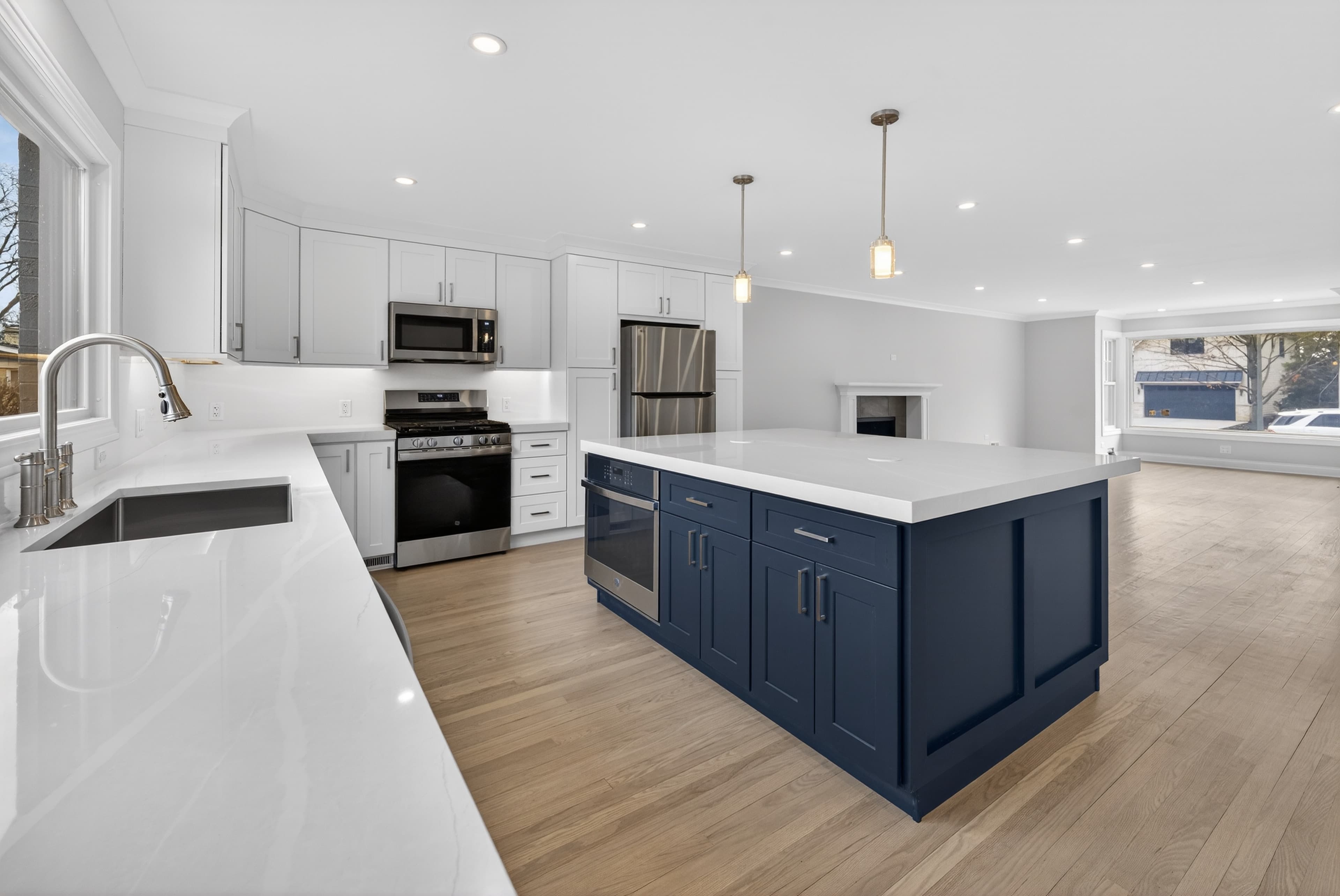 Modern kitchen remodel with dark island and open floor plan